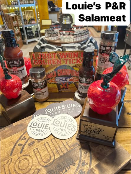 Glass-apple trophies, the golden ticket and Louie's seasonings on a table