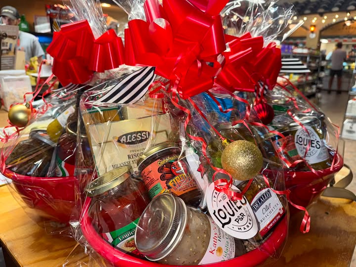 Gift basket of Louie's products wrapped with a red bow